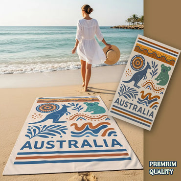 Woman on a beach with Australian-themed towels featuring kangaroos and Aboriginal patterns.