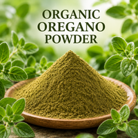 Organic oregano powder in a wooden bowl with fresh oregano leaves in the background